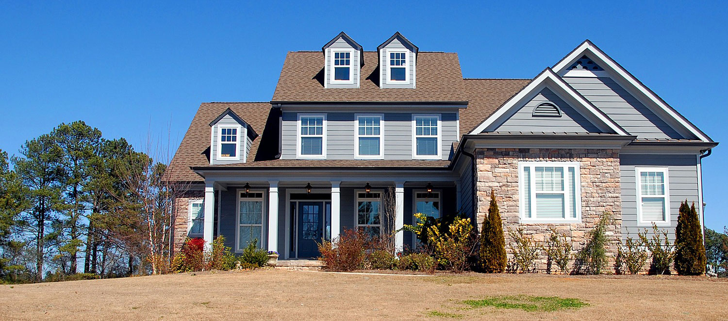 A blue grey vinyl gable vent on a light purple house.