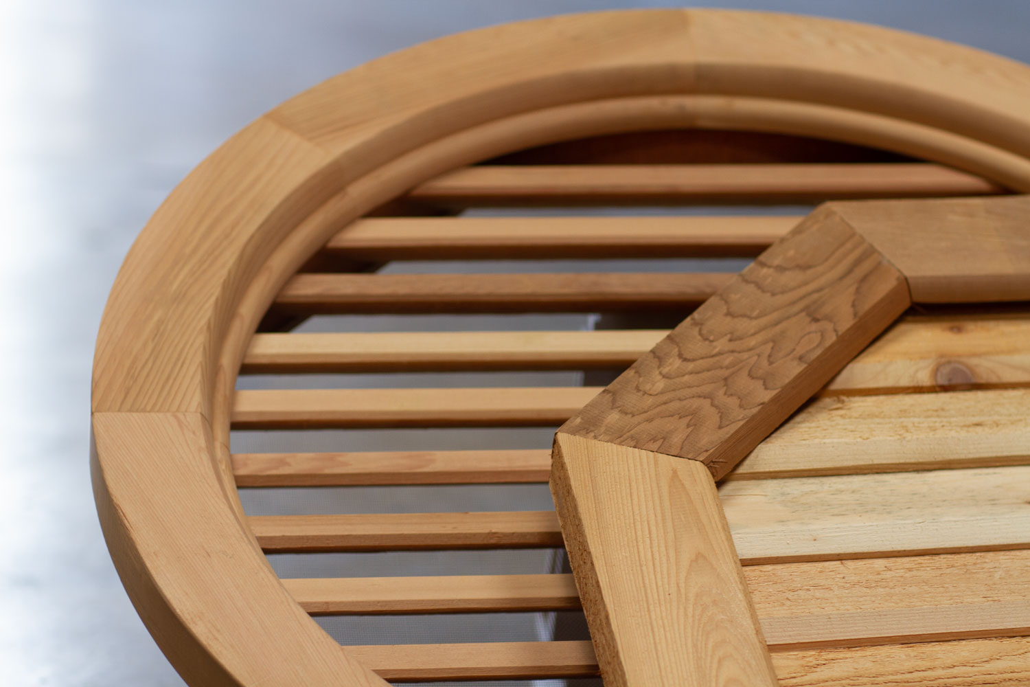 An image of a round wood gable vent with a octagon wood gable vent on top.