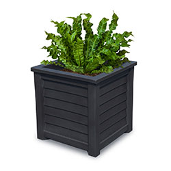Stylish planter box with textured sides, showcasing vibrant green plants. Perfect for enhancing outdoor spaces and adding a touch of elegance to gardens or patios. Ideal for urban gardening.